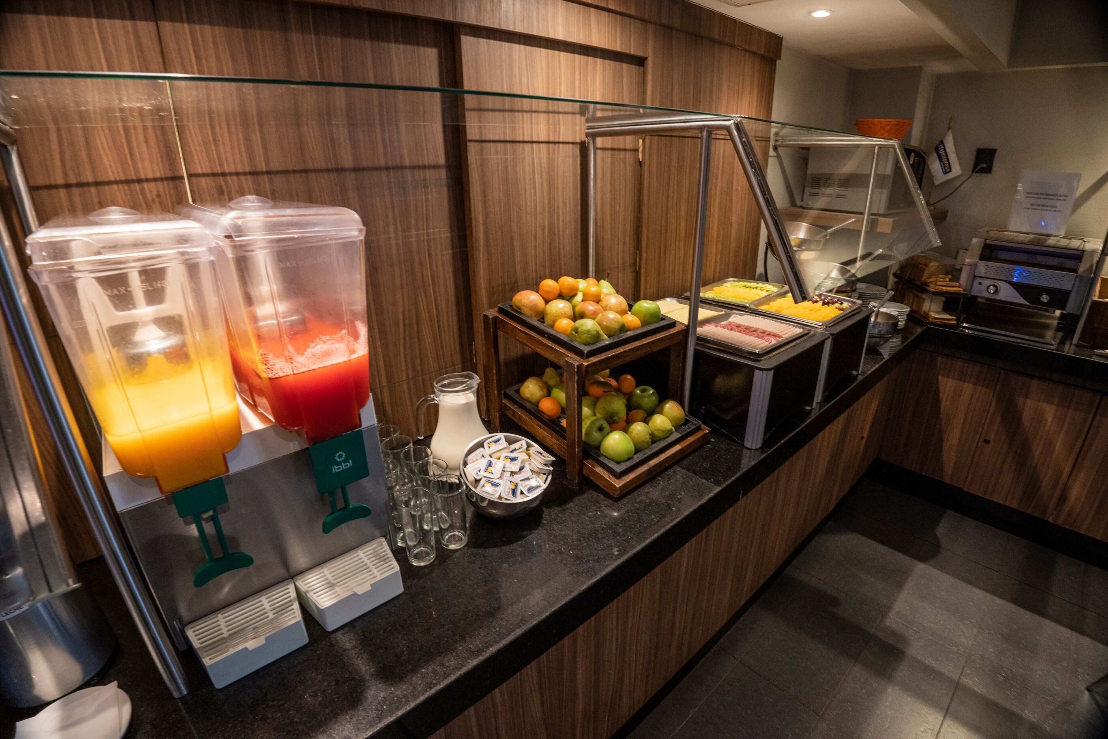 A buffet area with various food items and beverages.