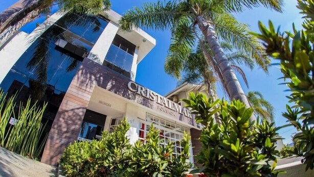 A modern building with the name 'CRISTALMAR' prominently displayed. - Pousada Cristalmar (Bombinhas)