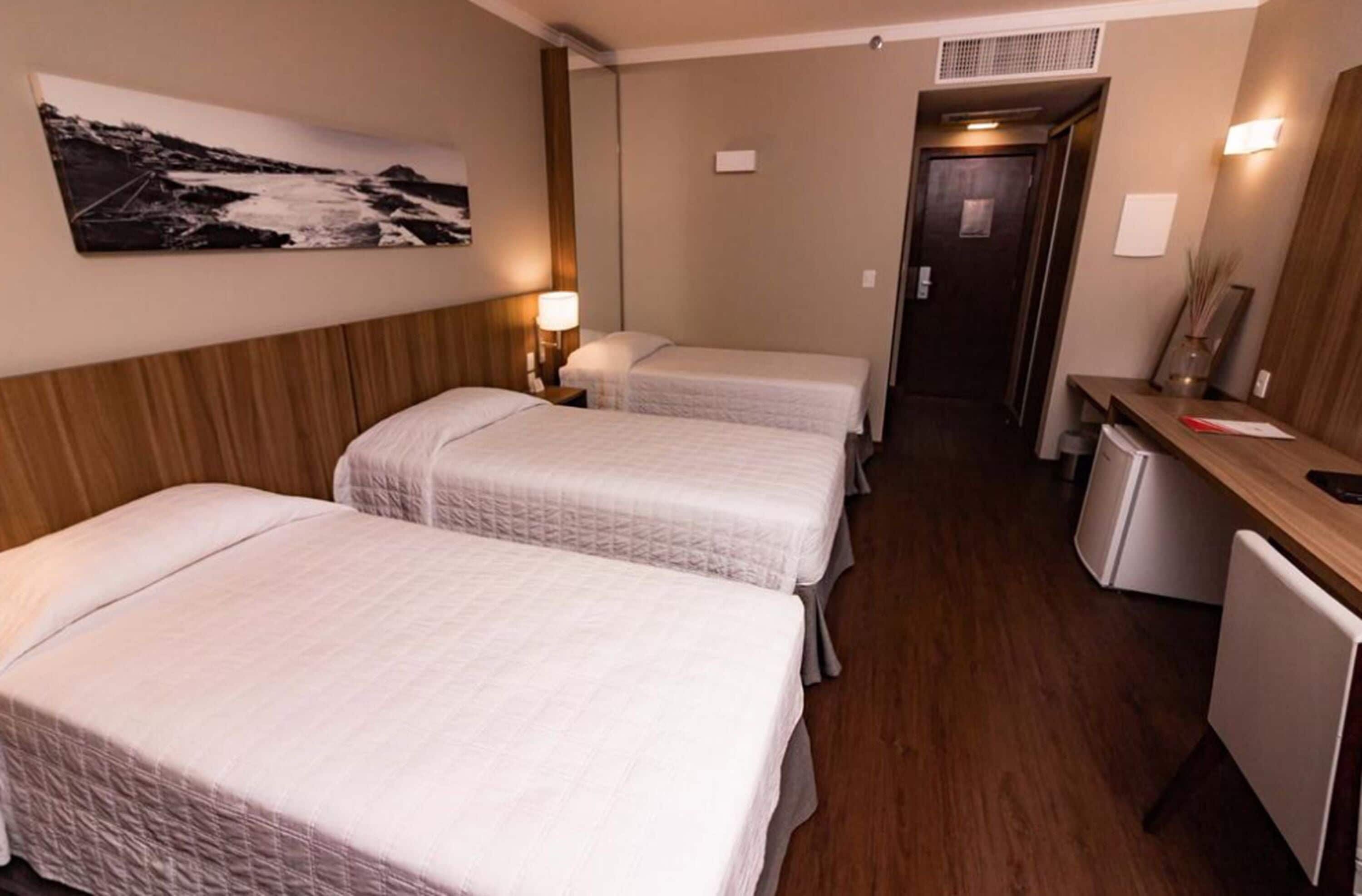 deluxe triple room | minibar, in-room safe, desk, blackout curtains