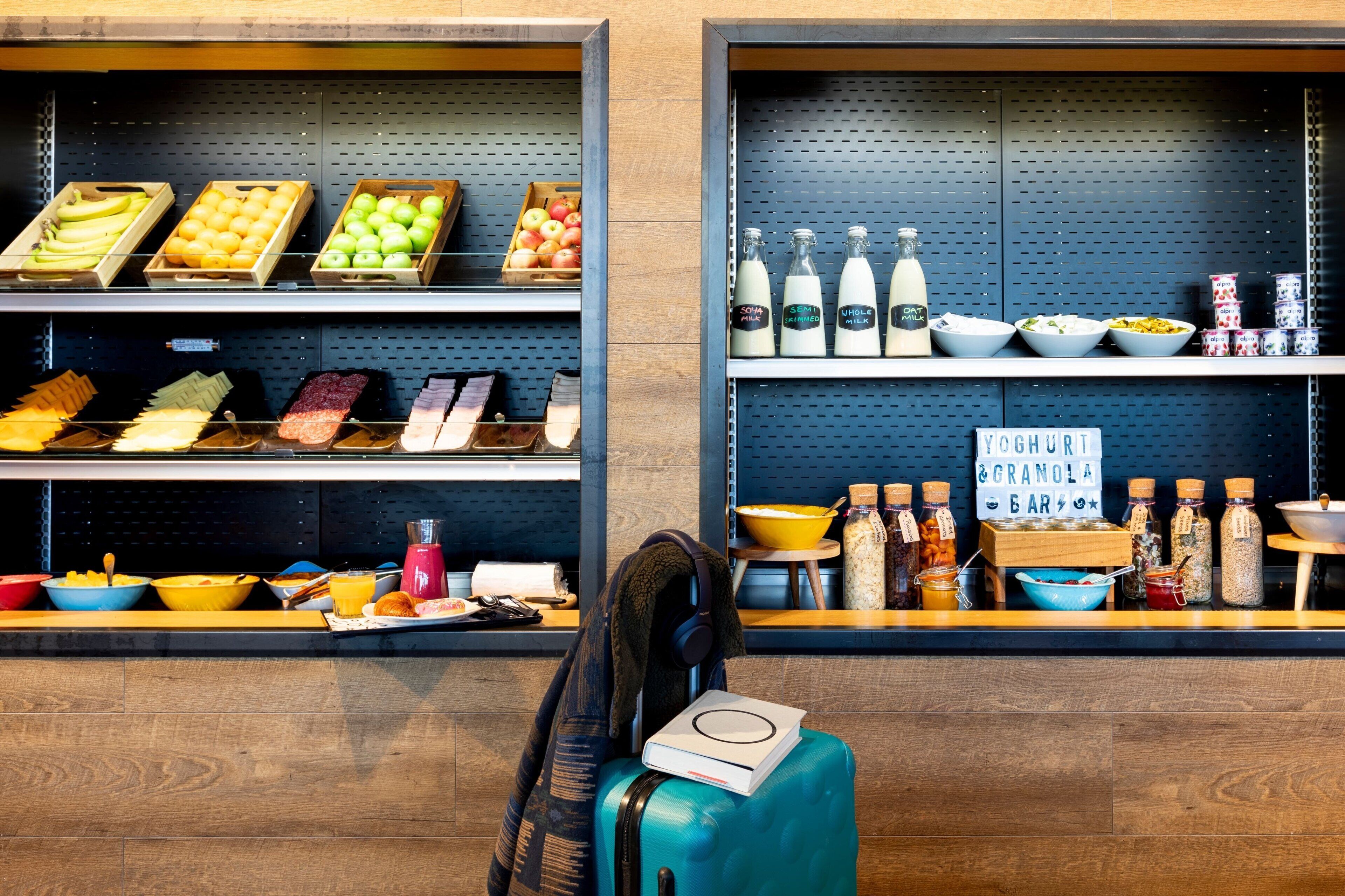 A breakfast bar with various food items and beverages.