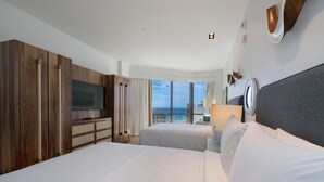 A hotel room with two beds, a TV, a large window with a view, and wooden paneling.