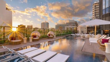 Outdoor pool, open 6:00 AM to 10:00 PM, free cabanas, pool umbrellas