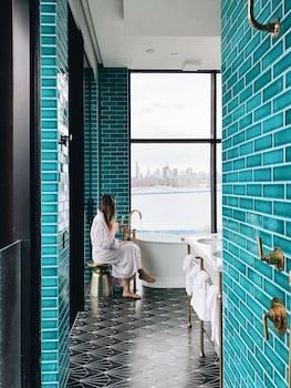 Shower, rainfall showerhead, free toiletries, hair dryer at Arlo Williamsburg