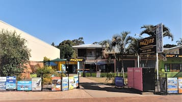 A hotel named 'BUZERS' with a reception area, accommodation options, and a sign for 'INFORMATION TOUR'.