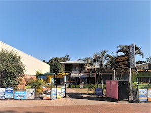 A hotel named 'BUZERS' with a reception area, accommodation options, and a sign for 'INFORMATION TOUR'. - Buzers (Torquay)