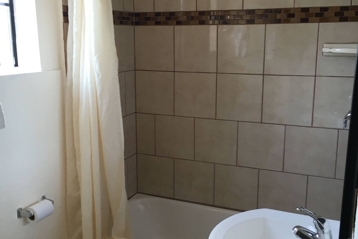 A bathroom with a bathtub, a sink, and a toilet.