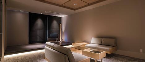 A modern living room with a sofa, a coffee table, and a TV.