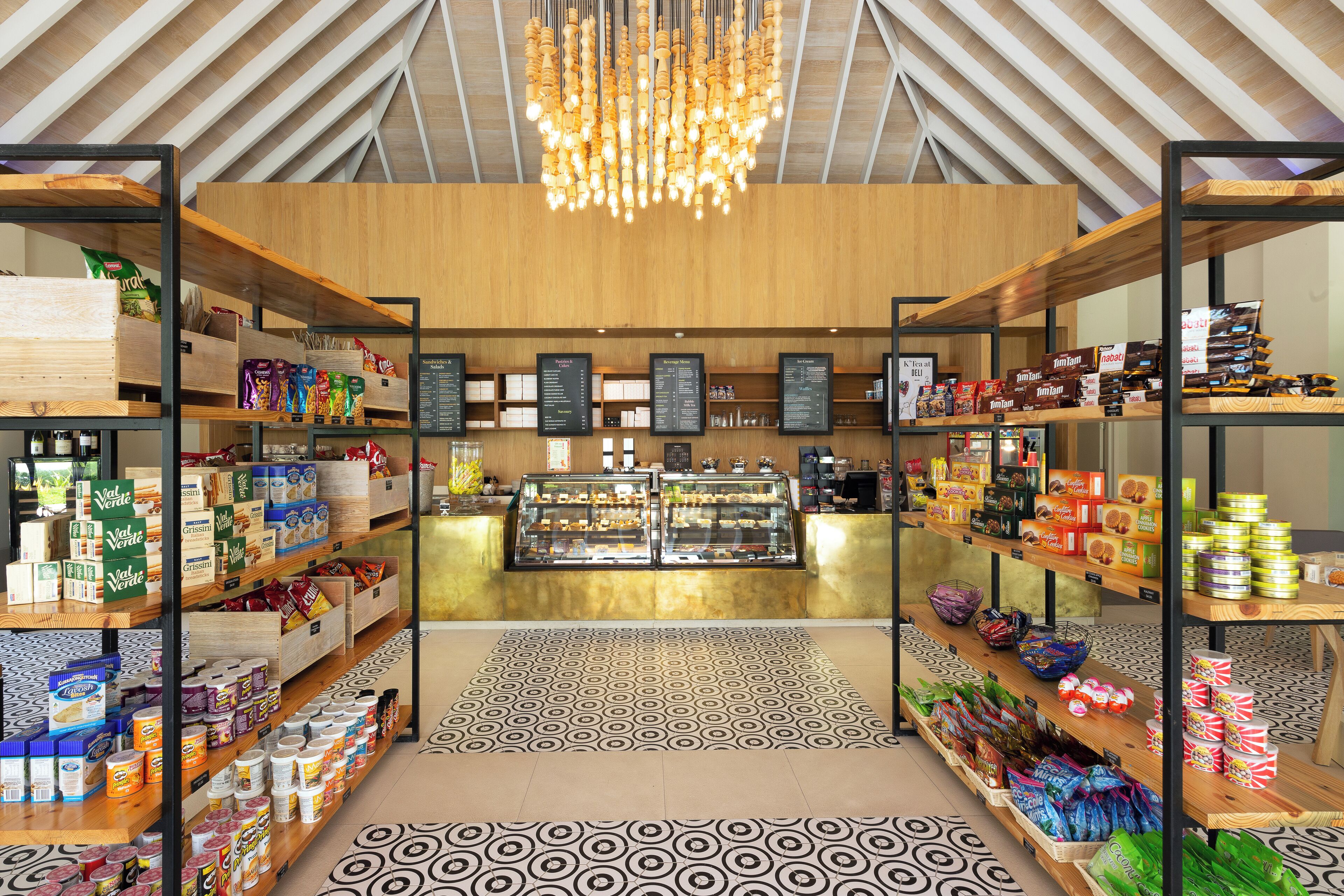 A modern retail space with wooden shelving, a central display case, and patterned flooring.