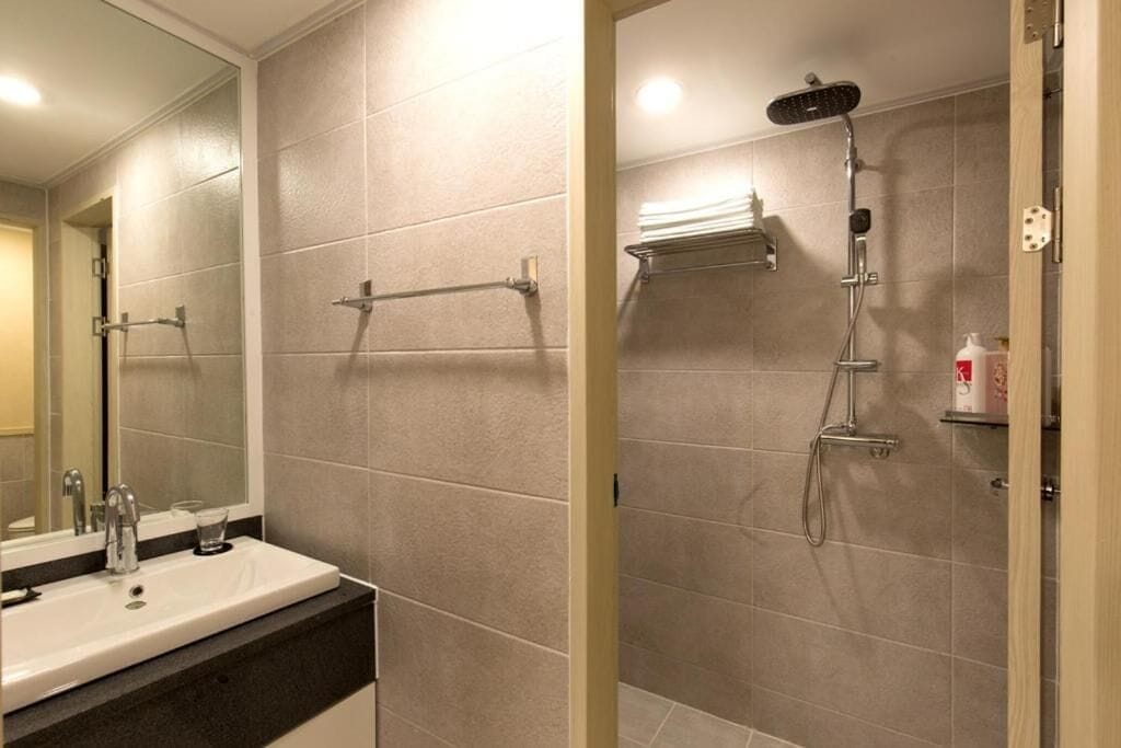 shower, hair dryer, slippers, towels