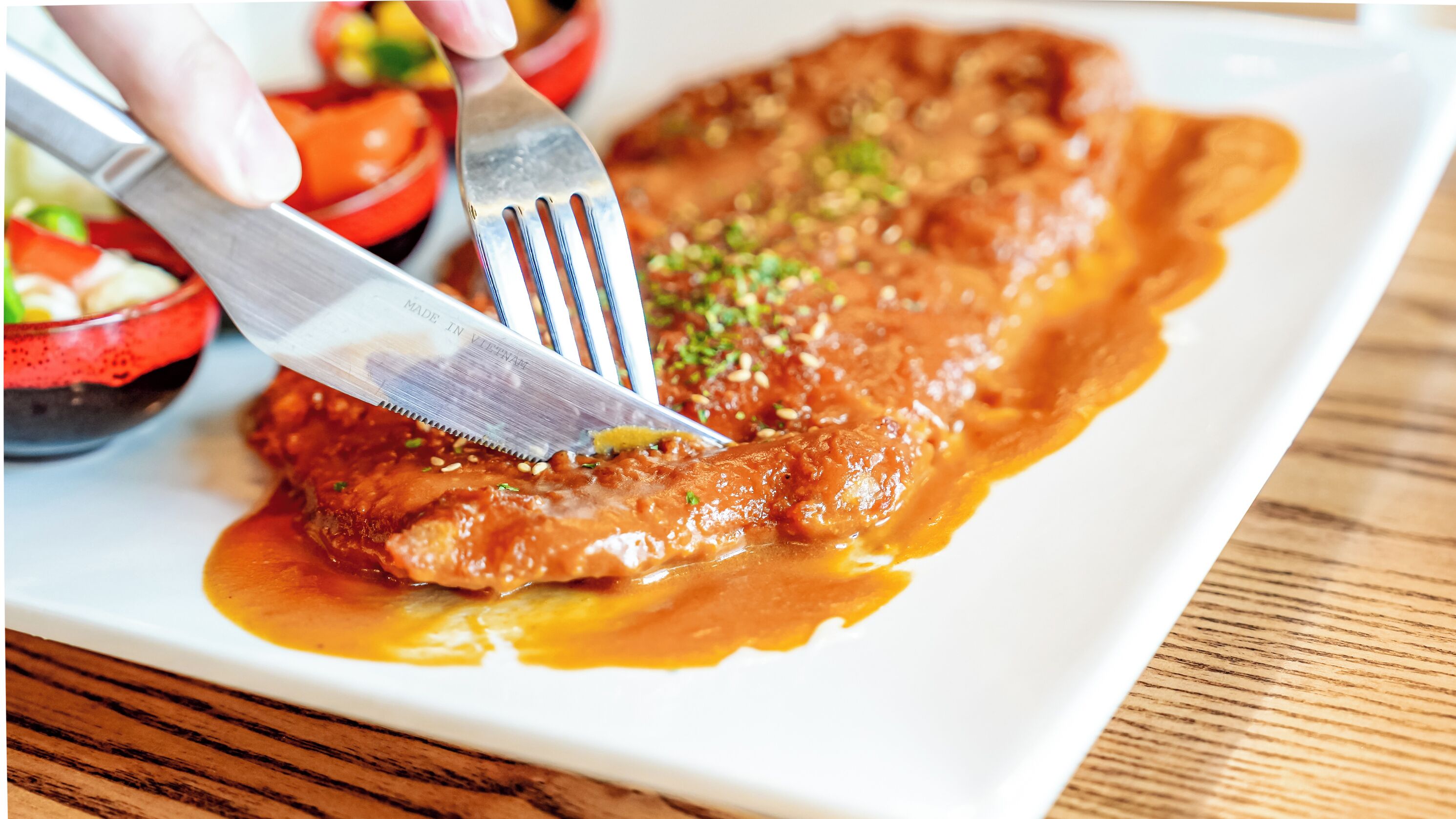 A plate of food with a fork and knife.