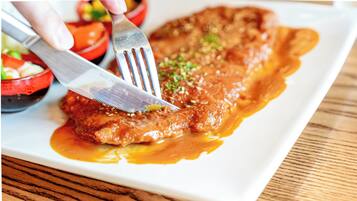 A plate of food with a fork and knife.