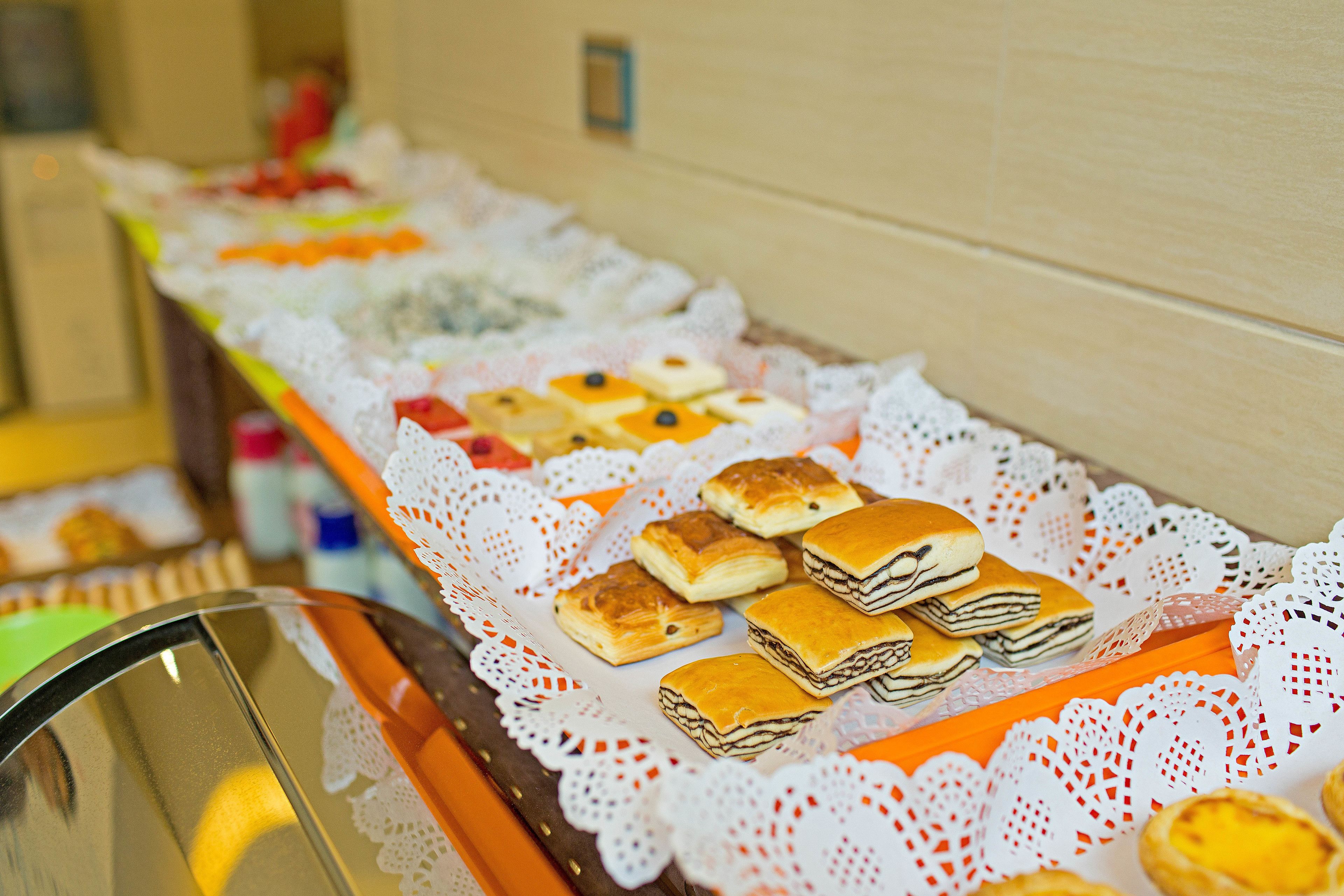 A buffet table with various pastries and desserts.