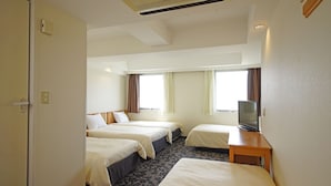 A hotel room with two beds, a TV, and a window with curtains. - Nansei Kanko Hotel (Naha)