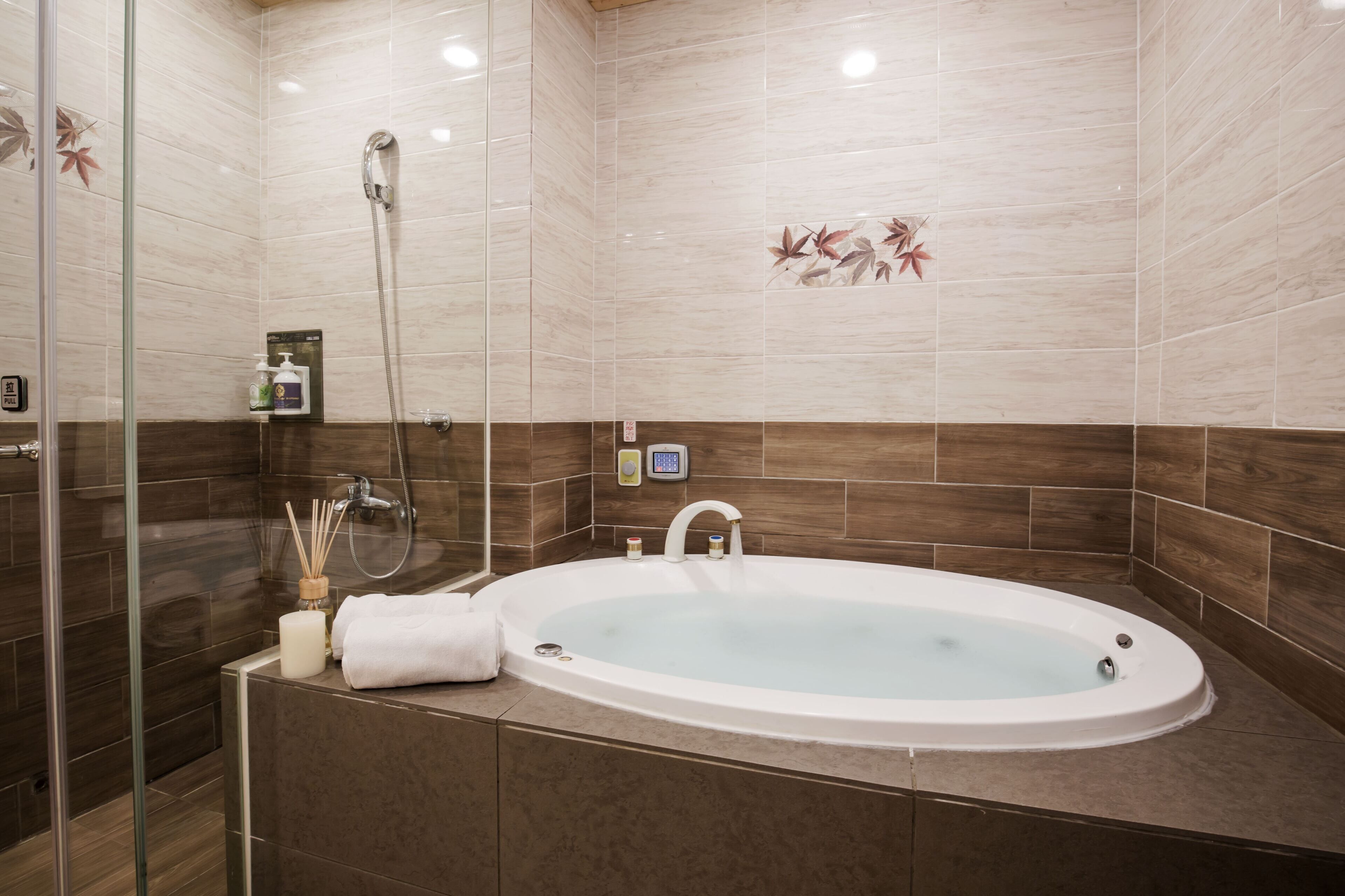 A modern bathroom with a freestanding bathtub, a glass shower enclosure, and a wooden vanity.