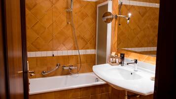 Une salle de bain avec une baignoire, un lavabo et une douche.
