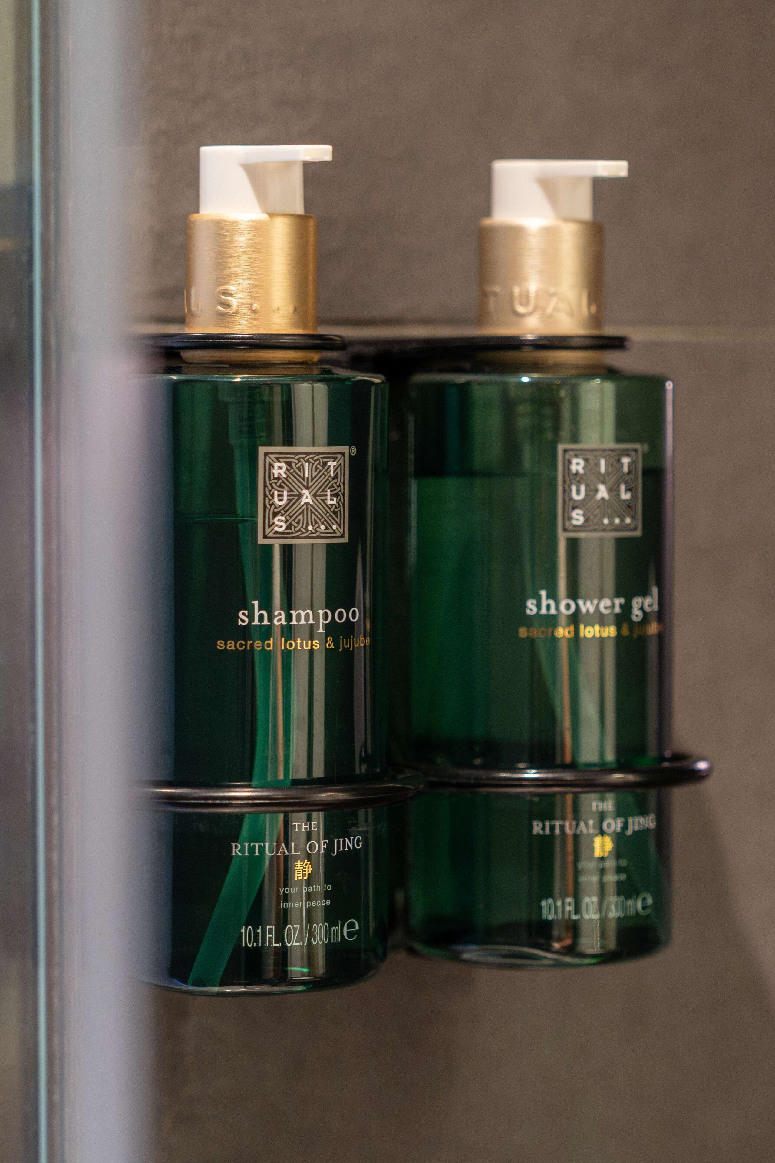 Two bottles of Ritual of Jing shampoo and shower gel.