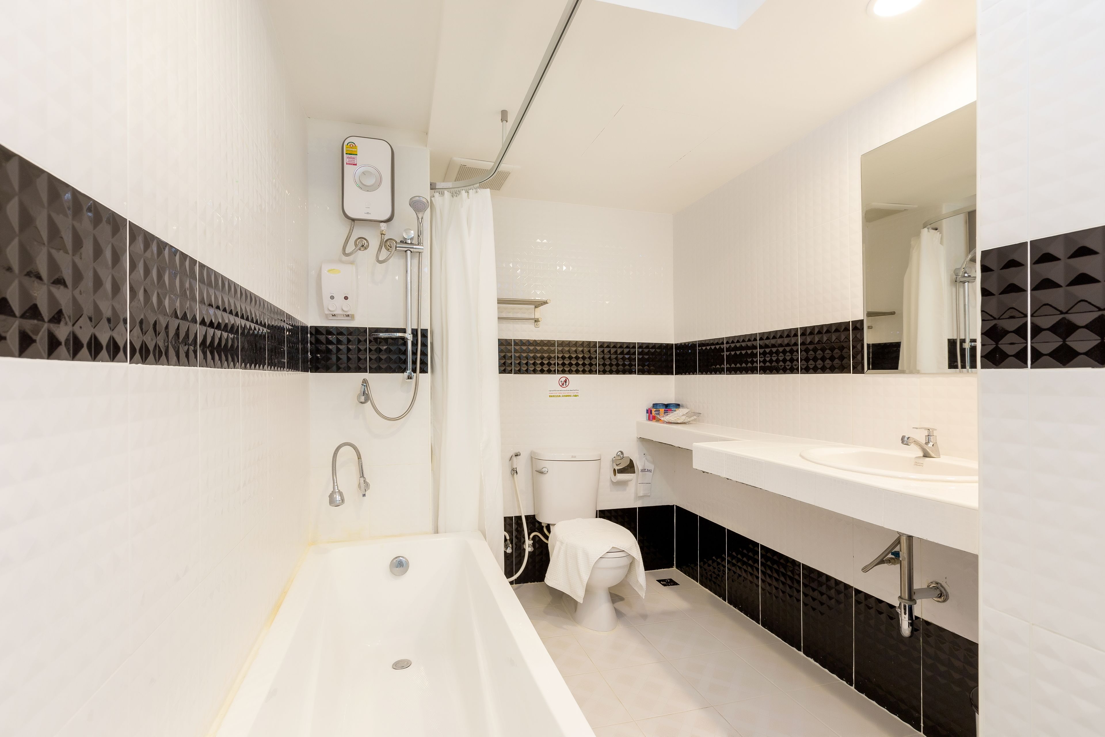 family grand suite room with bathtub | bathroom | shower, rainfall showerhead, hair dryer, towels