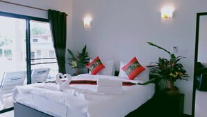 A hotel room with a large bed, two bedside tables, a window with curtains, and a view of the outside. - Naya Pool Villa (Rawai)