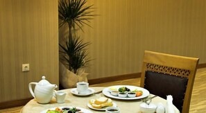 A dining table with a teapot, cups, plates with food, and a chair. - Buyuk Anadolu Eregli Hotel (Karadeniz Eregli)