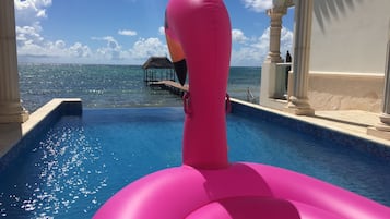 Enjoy a refreshing swim in the resort's pool, surrounded by a serene sea view.