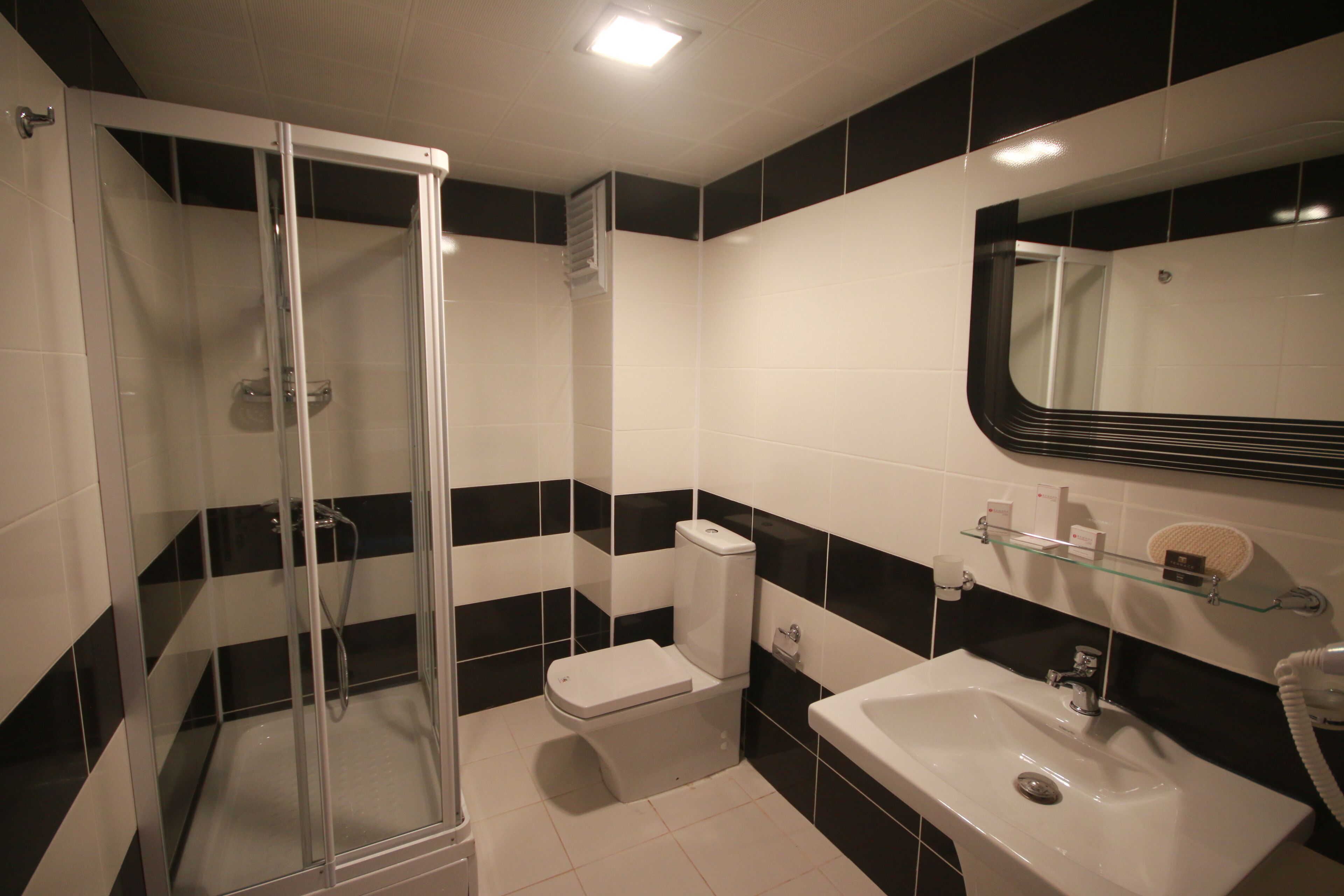 junior suite | bathroom | shower, free toiletries, hair dryer, slippers