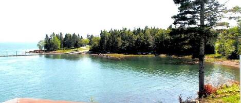 A lake with a wooden deck in the foreground.