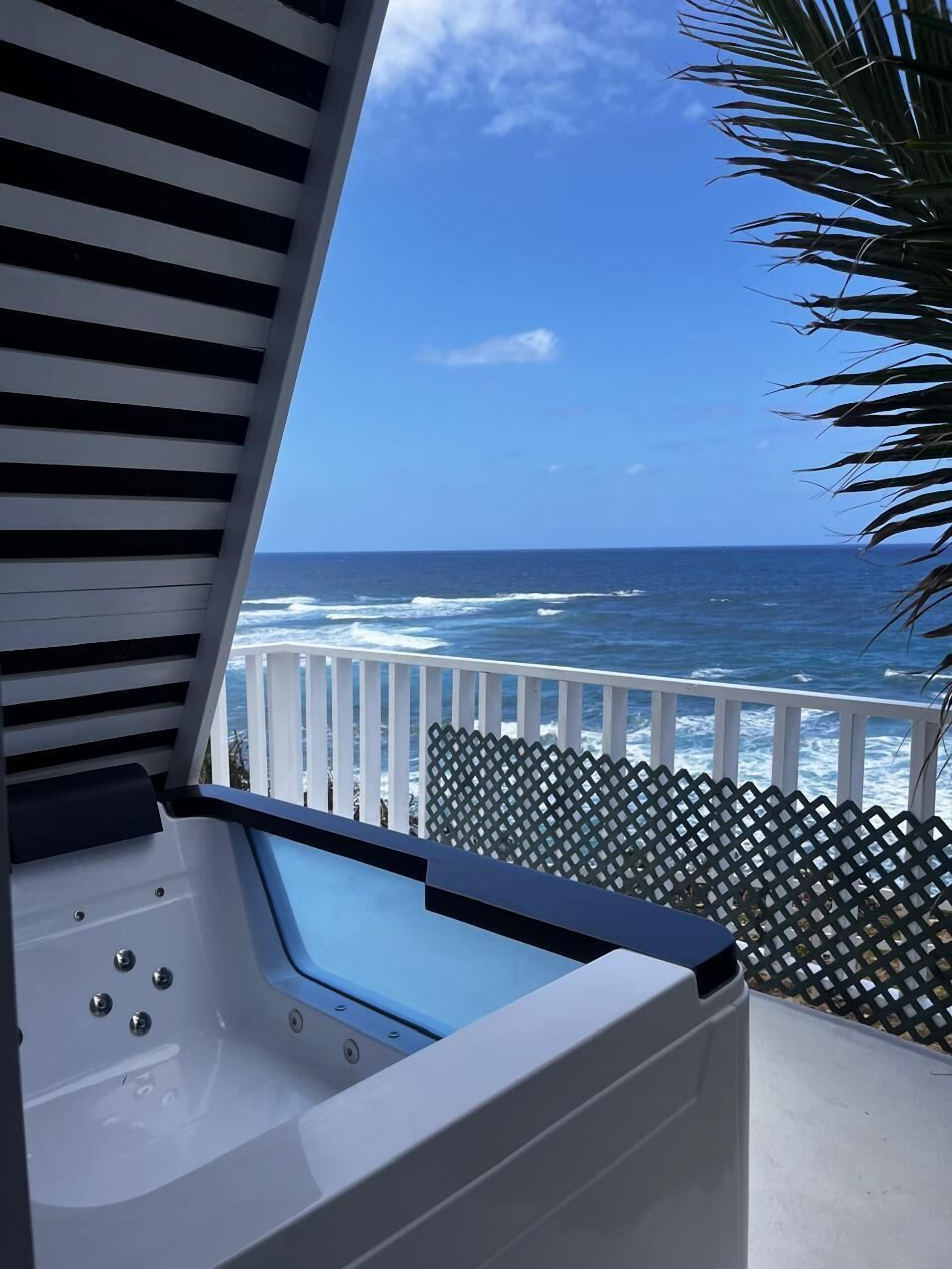 A hot tub with a view of the ocean.