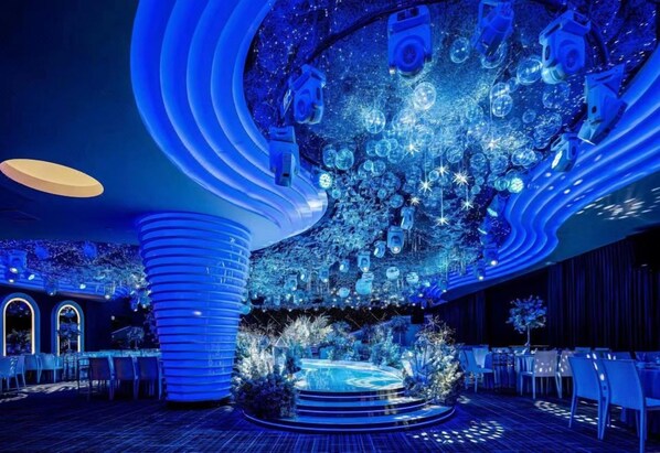 A modern interior with a circular seating area and a central stage.