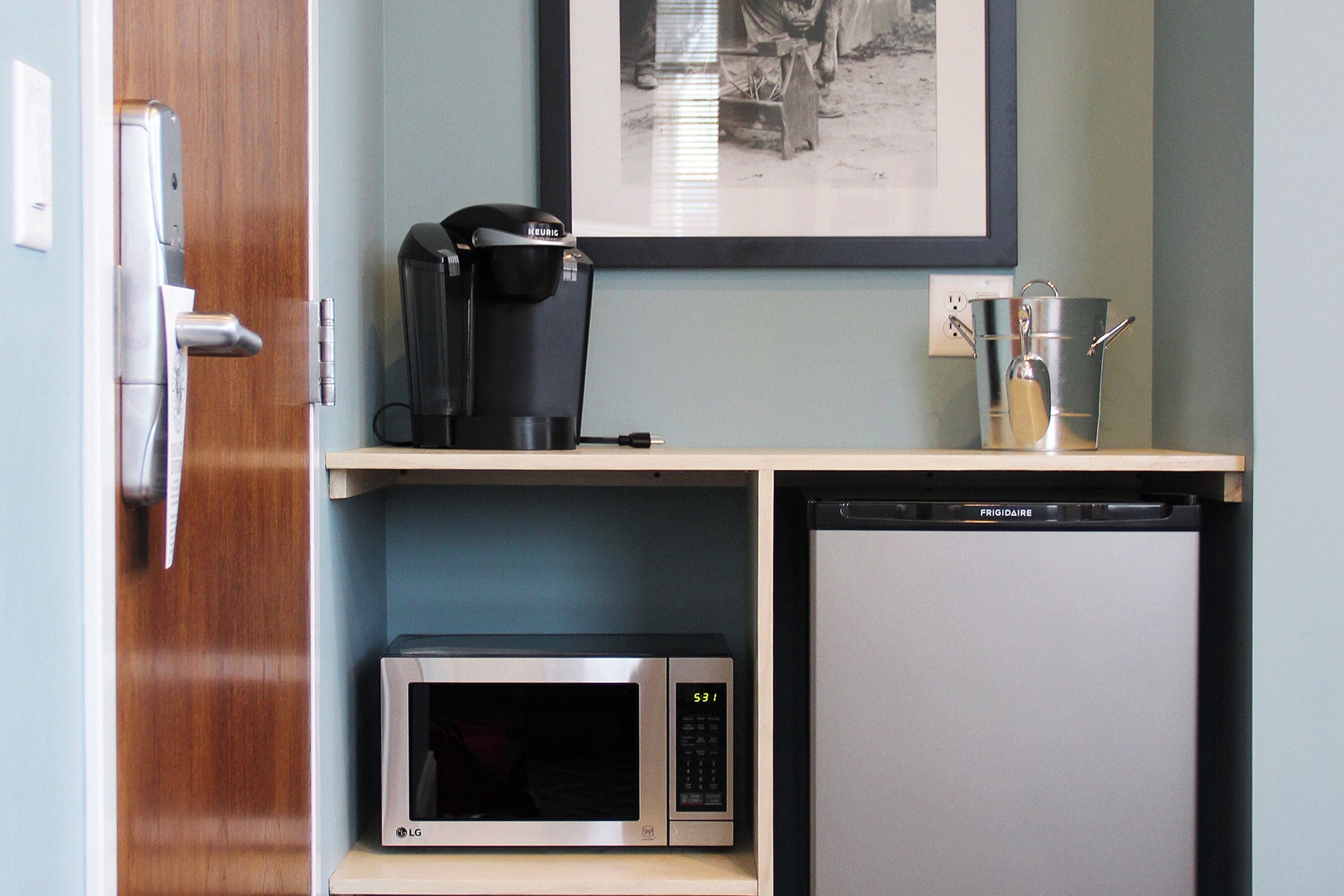 A compact kitchenette with a microwave, coffee maker, and a mini fridge.