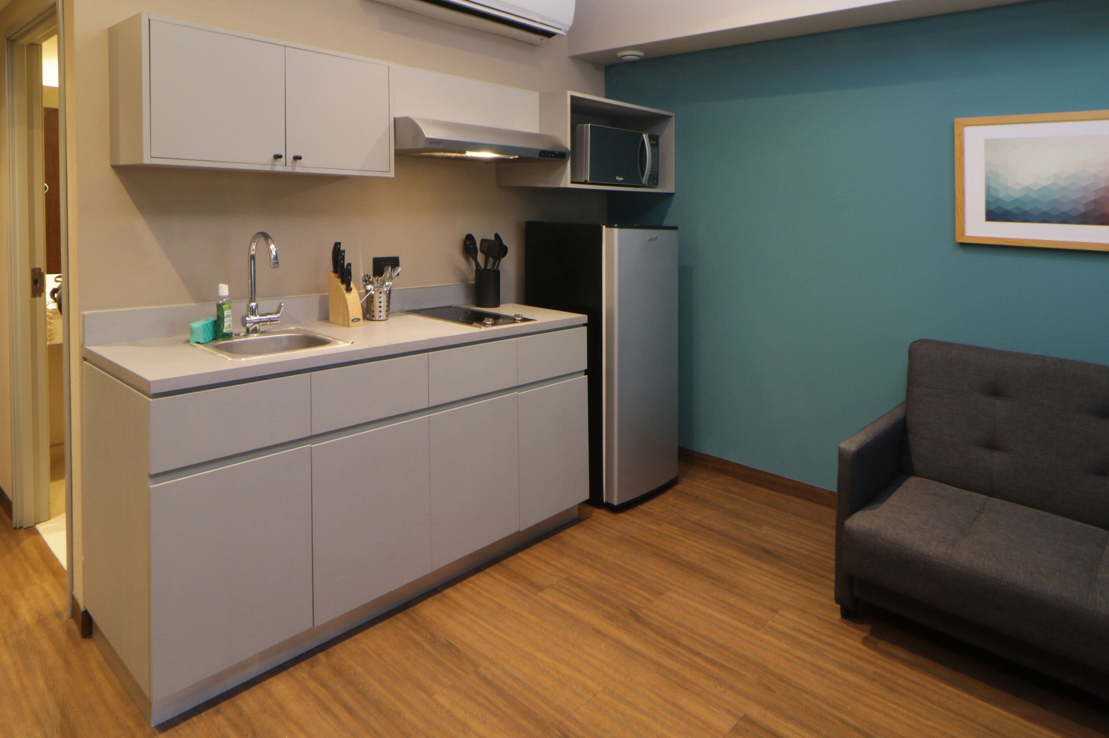 full-sized fridge, microwave, stovetop, coffee/tea maker