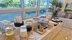 A breakfast buffet with various food items and beverages. - The Hotel Soo (Yeosu)