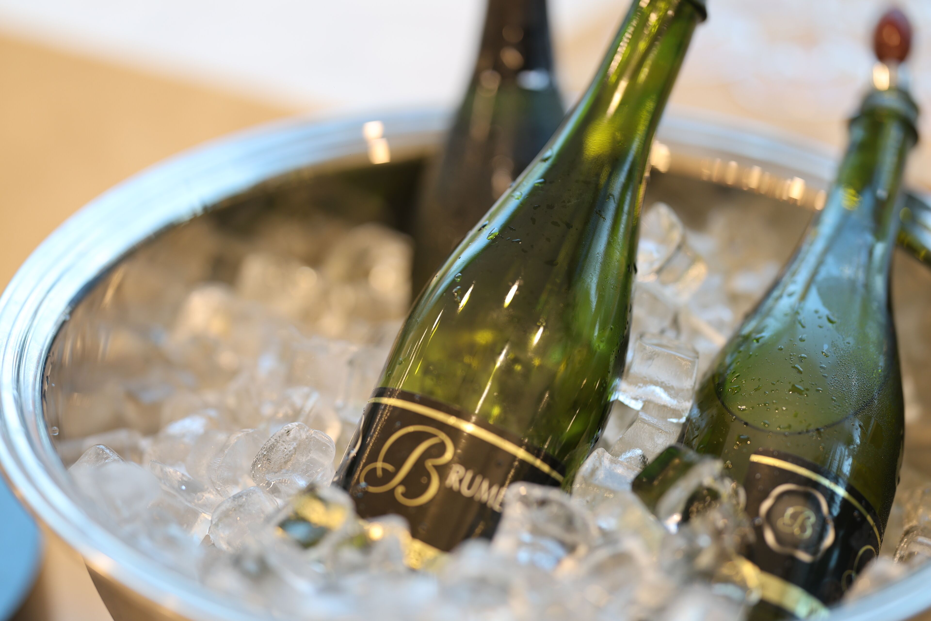 A bucket filled with ice and two champagne bottles labeled "Brut."