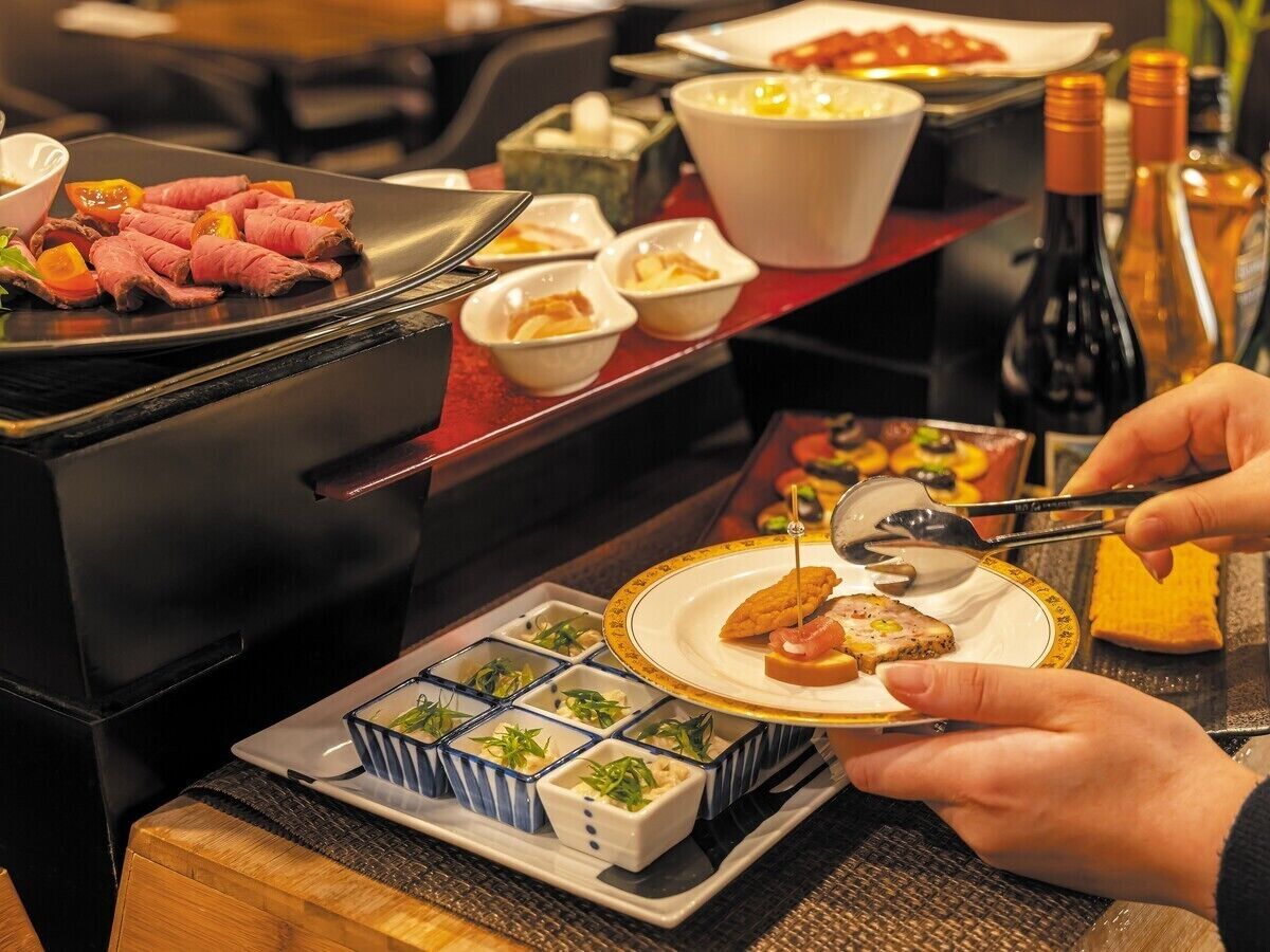 A dining area with a grill, various dishes, and condiments.