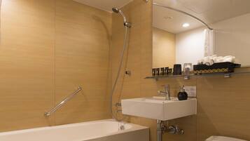 A modern bathroom with a bathtub, a toilet, and a sink.