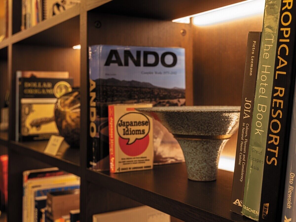 A bookshelf with books including 'Japanese Idioms' and 'The Hotel Book'.