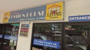 A pension house with a sign indicating it is a coffee shop and restaurant.