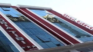 Un edificio de hotel con fachada moderna, amplios ventanales de vidrio y un cartel llamativo que dice "HOTEL BORIATIBI".