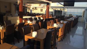 Guests can dine in comfort with multiple tables and chairs in this stylish dining area.