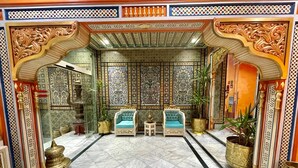 A luxurious lobby with ornate decor, two plush armchairs, and a large potted plant. - Royal Victoria - Ex British Embassy (Tunis)