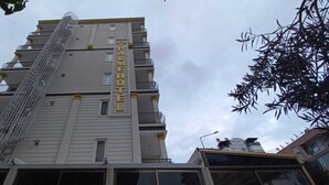 A multi-story hotel building with a prominent sign reading "PALME HOTEL". - Bayindir Palme (Antalya)