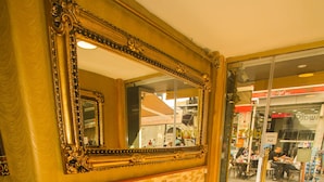 A reception area with two white armchairs, a small table with a vase of flowers, and a large ornate mirror on the wall. - Venue Hotel Old City Istanbul (Istanbul)