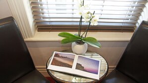 A small table with a book and a potted orchid. - Castle Hotel (Aberystwyth)