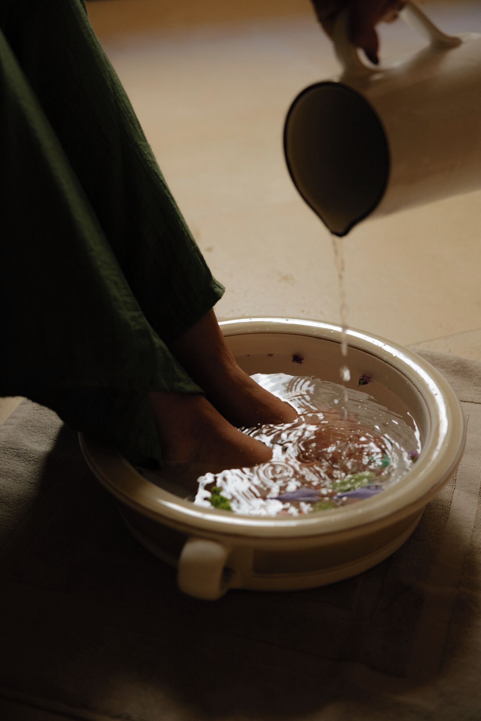 A person pouring water into a bowl.
