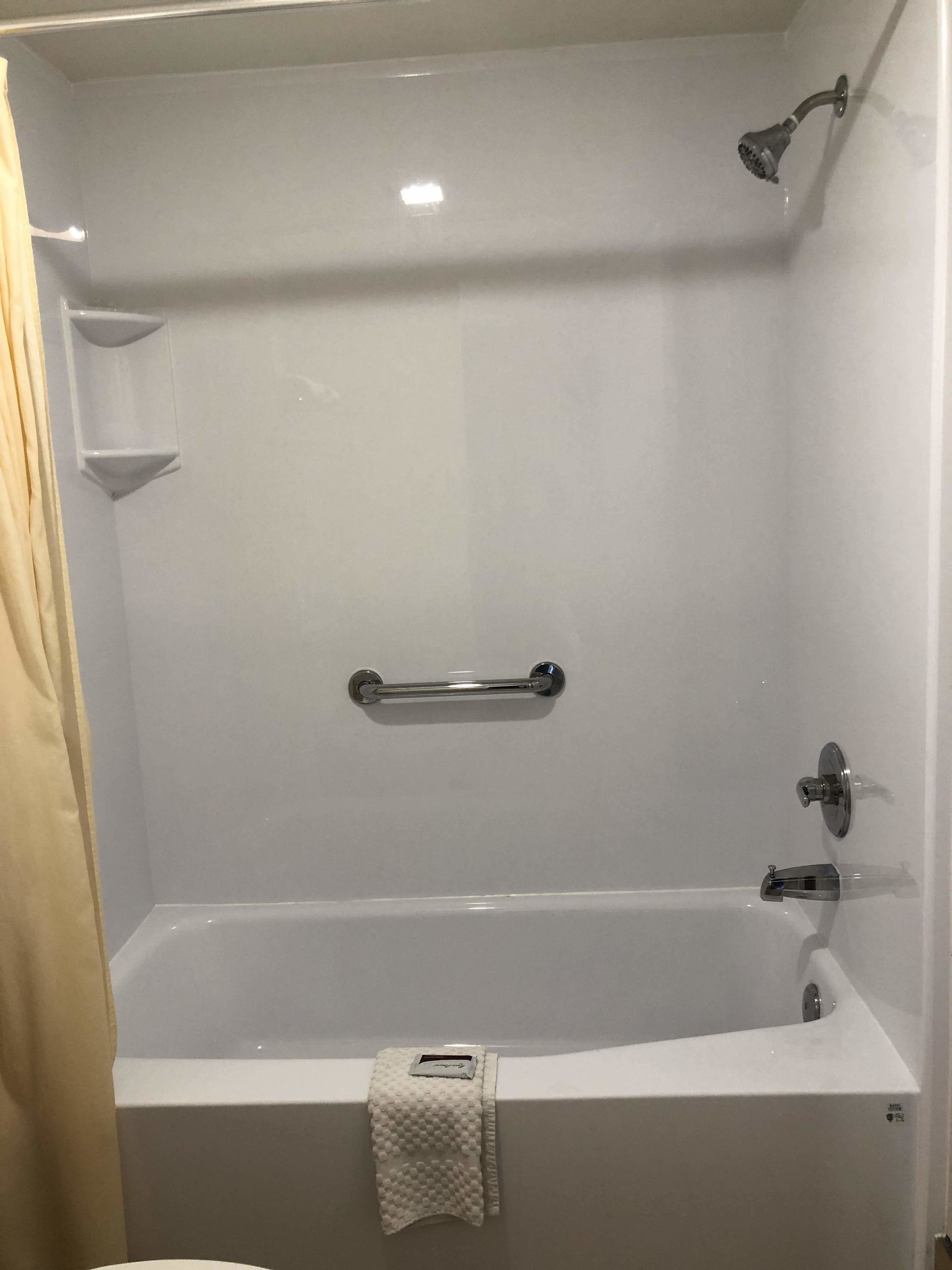 Combined shower/bathtub, designer toiletries, hair dryer, towels