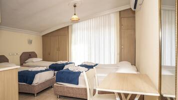 Standard Quadruple Room, 1 Bedroom | Minibar, desk, soundproofing, free WiFi
