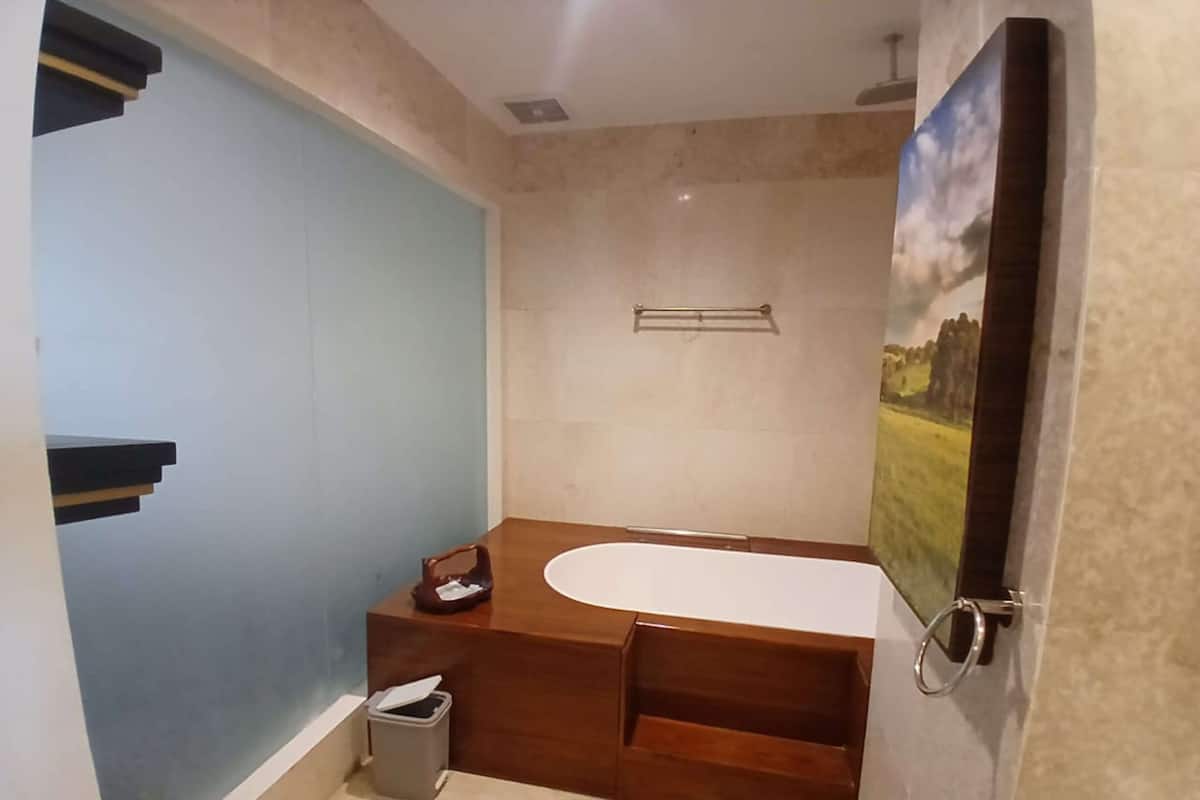 A bathroom with a bathtub, a toilet, and a sink.