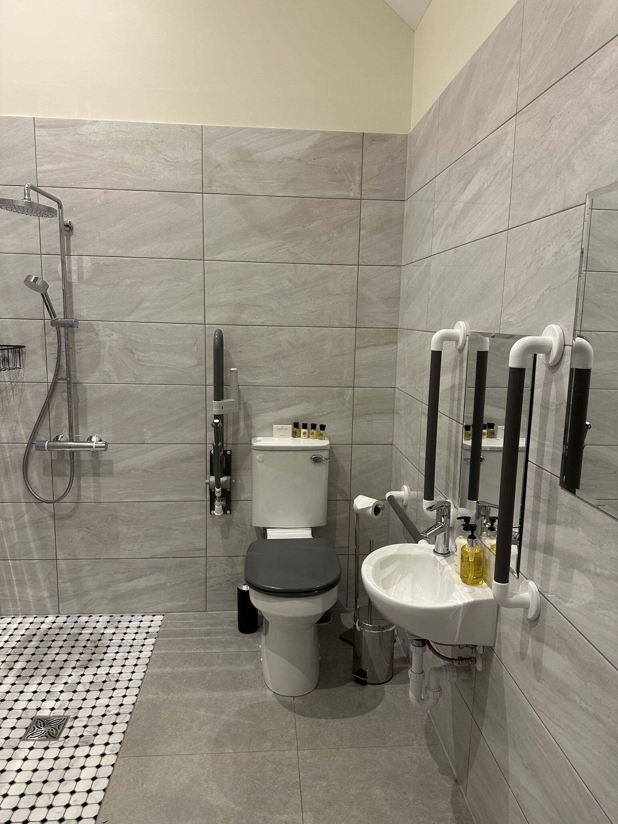 A modern bathroom with a toilet, bidet, and sink.