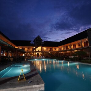 A hotel with a swimming pool, multiple guest rooms, and a large building with a distinct architectural style. - Sabda Alam Hotel & Resort (Garut)