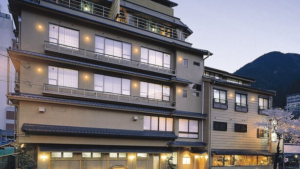A multi-story hotel with balconies, large windows, and a traditional architectural style. - Gero Onsen Kissenkan Chikusuitei (Gero)
