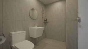 A modern bathroom with a toilet, sink, and shower. - Jeju Stay (Jeju City)
